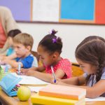 Pupils at desks with teacher